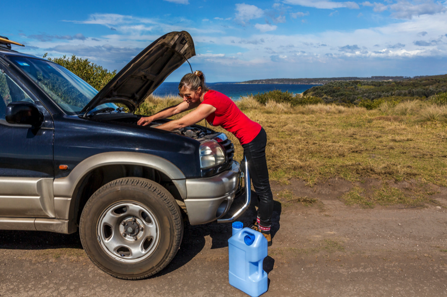 woman servicing engine of 4wd